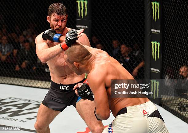 Dan Henderson punches Michael Bisping of England in their UFC middleweight championship bout during the UFC 204 Fight Night at the Manchester Evening...