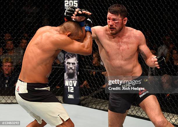 Michael Bisping of England punches Dan Henderson in their UFC middleweight championship bout during the UFC 204 Fight Night at the Manchester Evening...