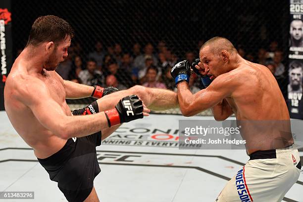 Michael Bisping of England kicks Dan Henderson in their UFC middleweight championship bout during the UFC 204 Fight Night at the Manchester Evening...