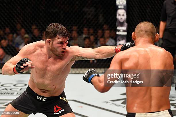 Michael Bisping of England punches Dan Henderson in their UFC middleweight championship bout during the UFC 204 Fight Night at the Manchester Evening...