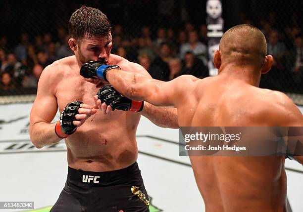 Dan Henderson punches Michael Bisping of England in their UFC middleweight championship bout during the UFC 204 Fight Night at the Manchester Evening...