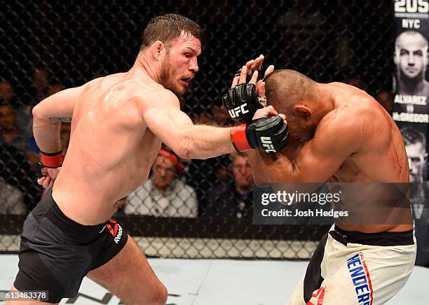 Michael Bisping of England punches Dan Henderson in their UFC middleweight championship bout during the UFC 204 Fight Night at the Manchester Evening...