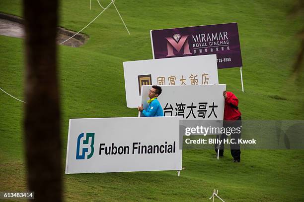 Workers move the signage boards in the Fubon Taiwan LPGA Championship on October 9, 2016 in Taipei, Taiwan.
