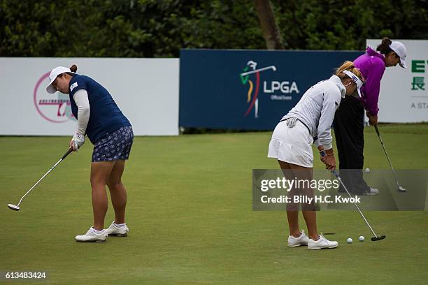 Alison Lee, Centre, Shanshan Feng, Left, practise before competition in the Fubon Taiwan LPGA Championship on October 9, 2016 in Taipei, Taiwan.