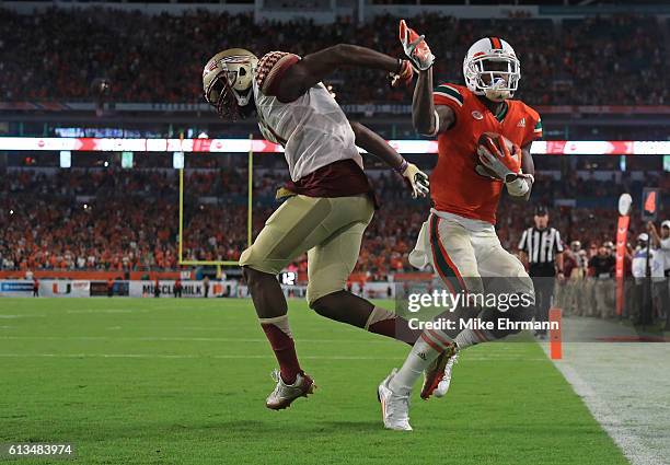 Stacy Coley of the Miami Hurricanes catches a touchdown over Tarvarus McFadden of the Florida State Seminoles during a game at Hard Rock Stadium on...