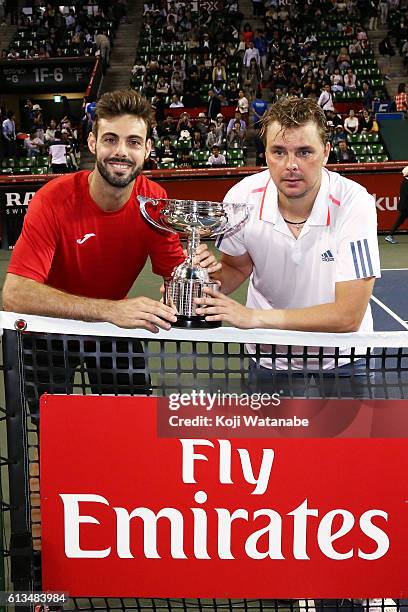 Marcel Granollers of Spain and Marcin Matkowski of Poland pose with a trophy after winning the men's doubles final match against Raven Klaasen of...