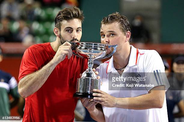 Marcel Granollers of Spain and Marcin Matkowski of Poland pose with a trophy after winning the men's doubles final match against Raven Klaasen of...