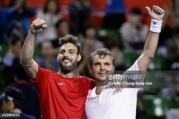 Marcel Granollers of Spain and Marcin Matkowski of Poland celebrate after winning the men's doubles final match against Raven Klaasen of South Africa...