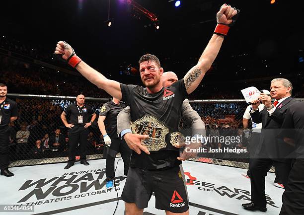 Michael Bisping of England celebrates his victory over Dan Henderson in their UFC middleweight championship bout during the UFC 204 Fight Night at...