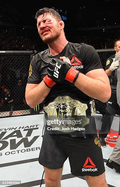 Michael Bisping of England celebrates his victory over Dan Henderson in their UFC middleweight championship bout during the UFC 204 Fight Night at...