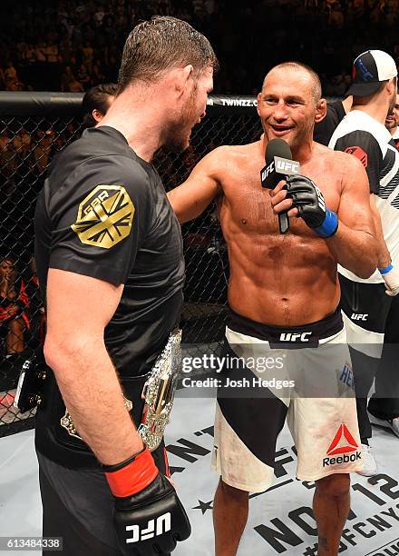 Dan Henderson chats with Michael Bisping of England after their UFC middleweight championship bout during the UFC 204 Fight Night at the Manchester...