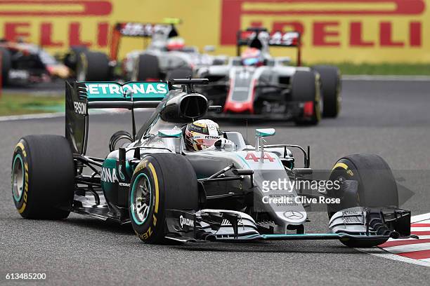 Lewis Hamilton of Great Britain driving the Mercedes AMG Petronas F1 Team Mercedes F1 WO7 Mercedes PU106C Hybrid turbo leads Romain Grosjean of...
