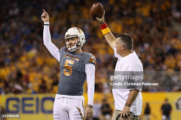 After kicking a 46 yard field goal, place kicker Zane Gonzalez of the Arizona State Sun Devils is congratulated by head coach Todd Graham for...