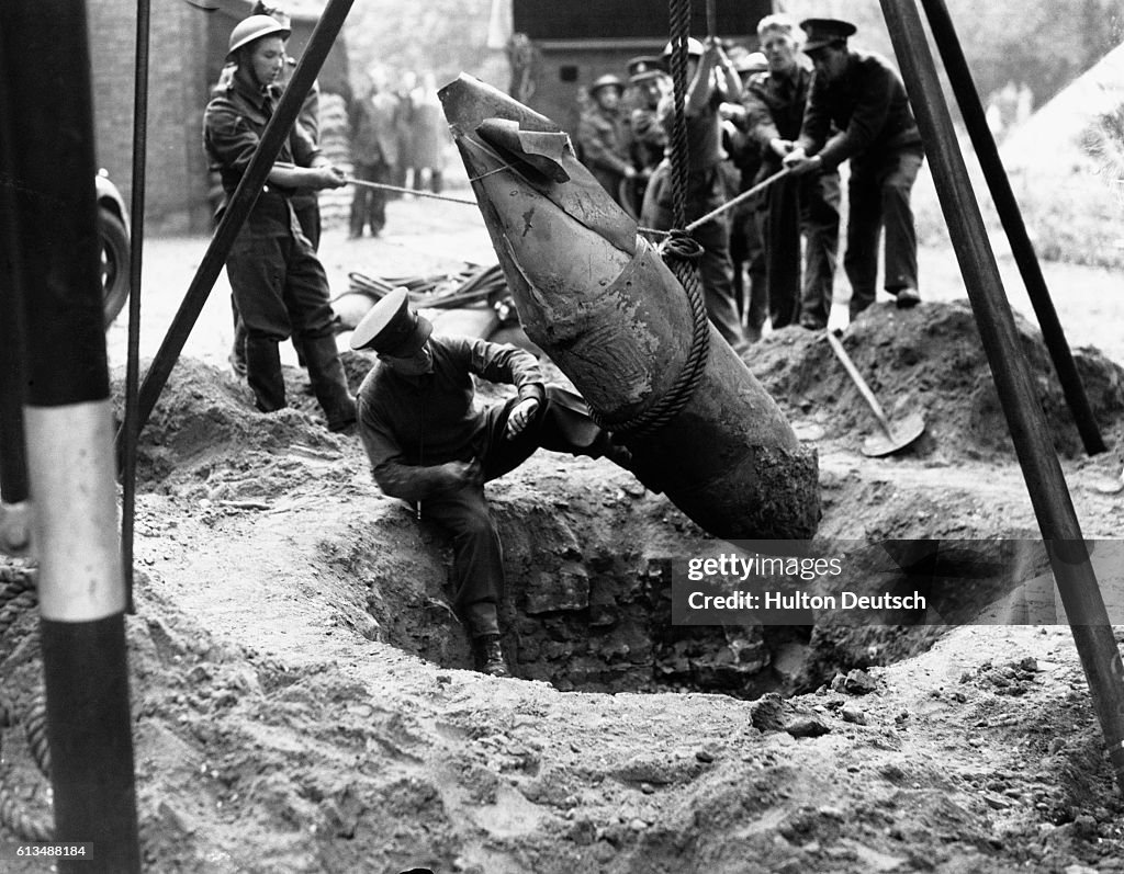 Bomb Diffusing Armor Lieutenant R. Davies, commander of a bomb disposal unit, carefully ...
