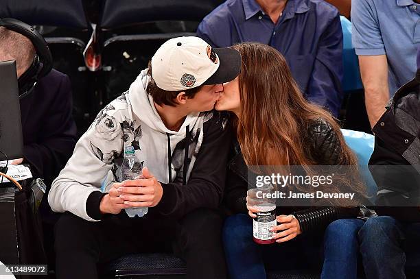 Ansel Elgort and Violetta Komyshan attend New York Knicks vs Brooklyn Nets preseason game at Madison Square Garden on October 8, 2016 in New York...