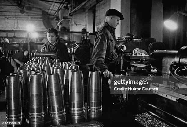 Workers test artillery shells for the Russian armed forces in a ordnance factory in Moscow.