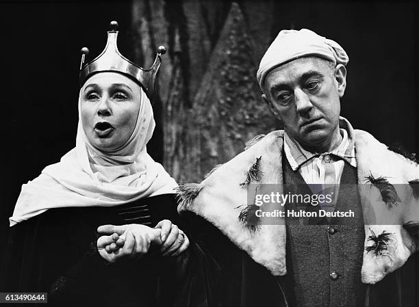 Alec Guinness as King Berenger I with his wife played by Googie Withers, in a scene from Exit the King at the Royal Court Theatre, 1963.