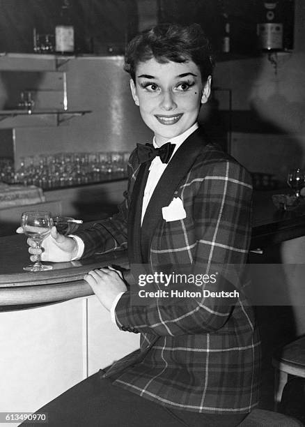 Actress Audrey Hepburn wearing a tartan dinner jacket, 1950.