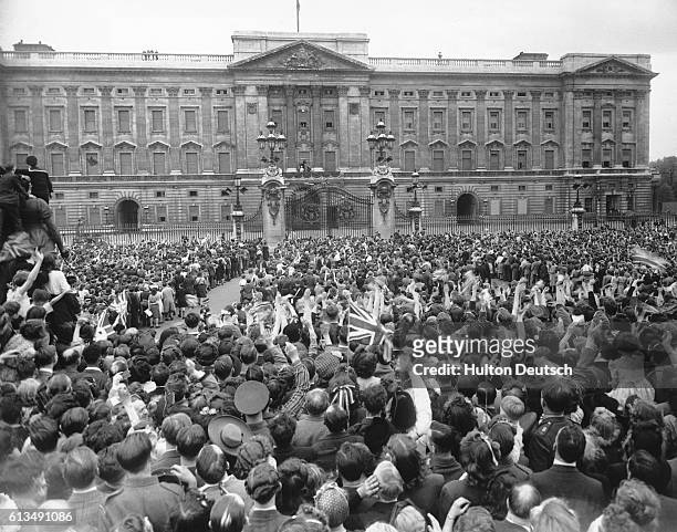 Day In London. The crowd gathered outside Buckingham Palace, cheer and wave as their Majesties the King and Queen with the Princesses Elizabeth and...