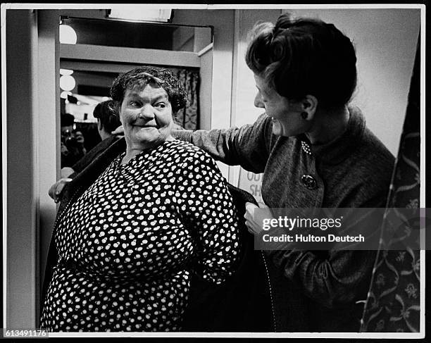 Fitting room attendant helps a customer try on clothes at an Evans clothing store which caters for the larger woman.