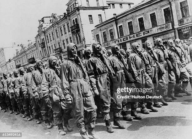 Civilians wear gas masks and chemical suits during a drill held in Kiev, USSR.