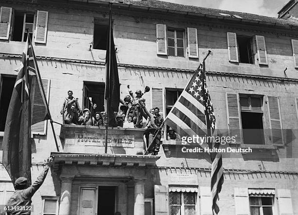 Flags fly from the town hall of Cherbourg in celebration of the liberation of the town from German occupation by the Allied Forces, June 1944.