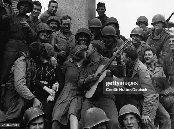 The liberation of Cherbourg was enthusiastically received by its inhabitants. The people danced and sang and the girls made a terrific fuss of the...