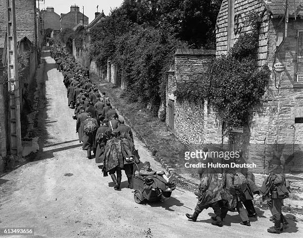 German prisoners of war are marched though Cherbourg after the liberation of the town by the Allies, ca. 1944.