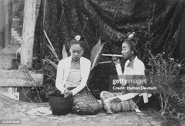 Couple Of Burmese Young Ladies, One Of Whom Is Engaged In Making Cheroots An Occupation Which Fills Up A Good Deal Of Their Time, The Demand For...