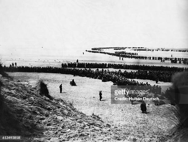 British & French troops waiting on the dunes at Dunkirk to be picked up by the destroyers to bring them back to England during the Dunkirk...