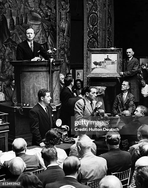 Painting by Monet is shown to buyers in the main auction room at Sotheby's during the sale of the Wainberg collection of French masters.