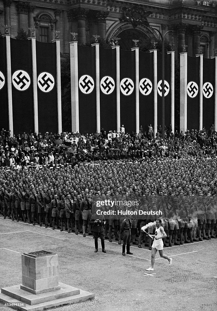 Olympic Torch Bearer Passing Nazi Banners, Berlin, 1936
