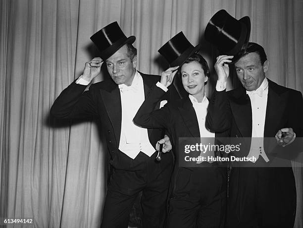 Actor Laurence Olivier, actress Vivien Leigh and actor John Mills on stage at the Royal Variety Performance, 1956.