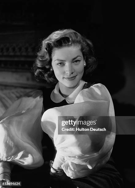 Actress Lauren Bacall wears a blouse with very puffy sleeves.