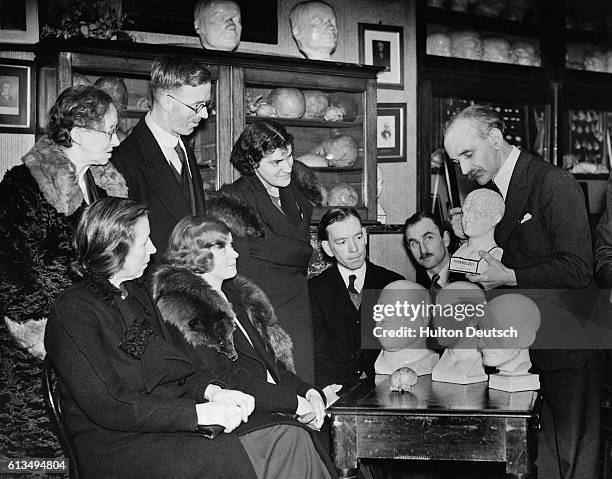 Mr J. L. Barr conducts a phrenology lesson using head models at a branch of the British Phrenological Society in London.