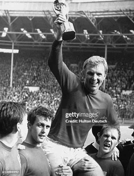 Ray Wilson and Geoff Hurst carry Bobby Moore as he celebrates England's victory in the 1966 Soccer World Cup at Wembley, London.