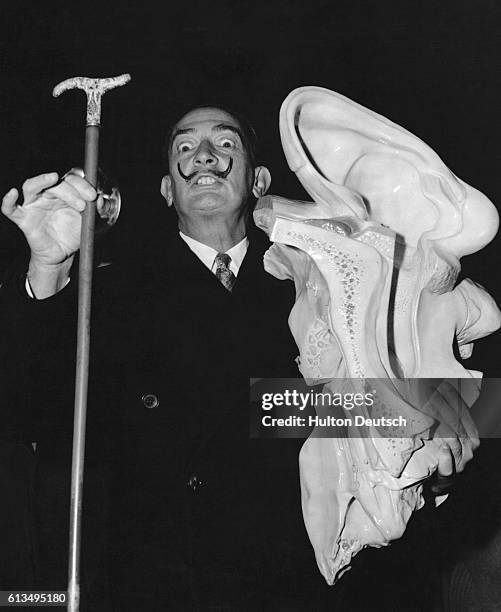 The eccentric, Spanish, Surrealist, painter Salvador Dali with a large, plastic, ear which he heralds as his new "source of inspiration".