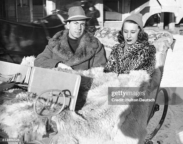 The former Prince Sigvard of Sweden, now Count Sigvard Bernadotte, rides in a sleigh in St.-Moritz Switzerland with his wife Erika in 1938.