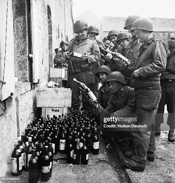 Troops from the US 4th Division, discover a hoard of wine, left by the Germans in Cherbourg, 1944.