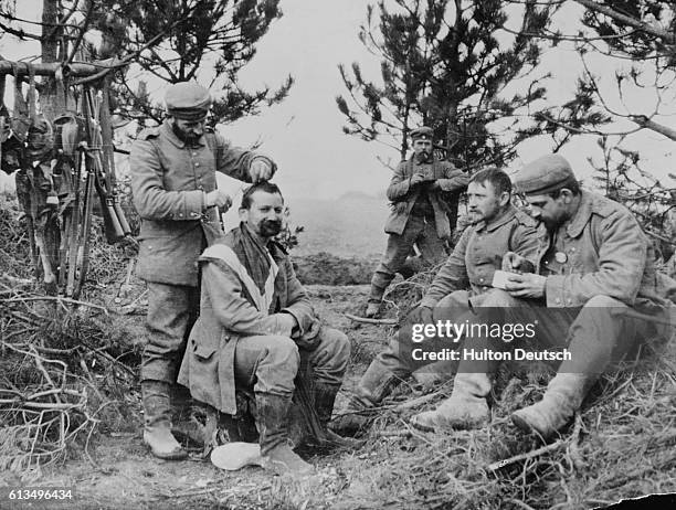 Soldier receives a haricut during a break in the hostilities, ca. 1915.