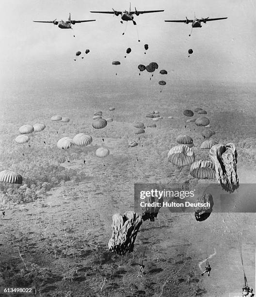 United States Air Force C-123 aircraft drop Vietnmaese paratroopers during an initial aerial attack on Viet Cong forces in Nay Tinh province, as part...