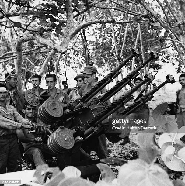 Cuban soldiers demonstrate a beach gun they used during the Bay of Pigs invasion of 1961. | Location: Playa De Giron, Cuba.