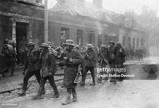 Group of wounded German and British soldiers make their way through the streets of St. Quentin. The Battle of the Somme was costly in terms of...