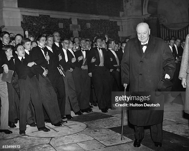 The former Conservative Prime Minister and war-time leader Winston Churchill is cheered by boys, during his annual visit to his old school, Harrow.