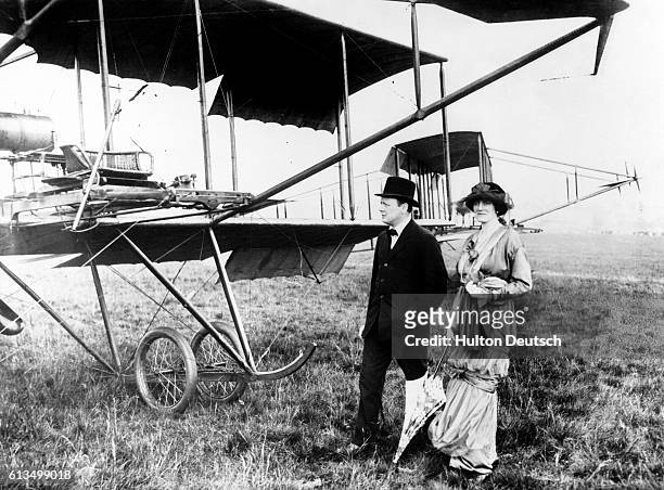 The politician Winston Churchill with his wife Clementine beside an early aircraft at Hendon, 1914.