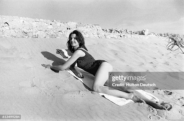 Christine Keeler, the English model and show girl notorious for her affair with John Profumo a Conservative cabinet minister, sunbathes on a Spanish...