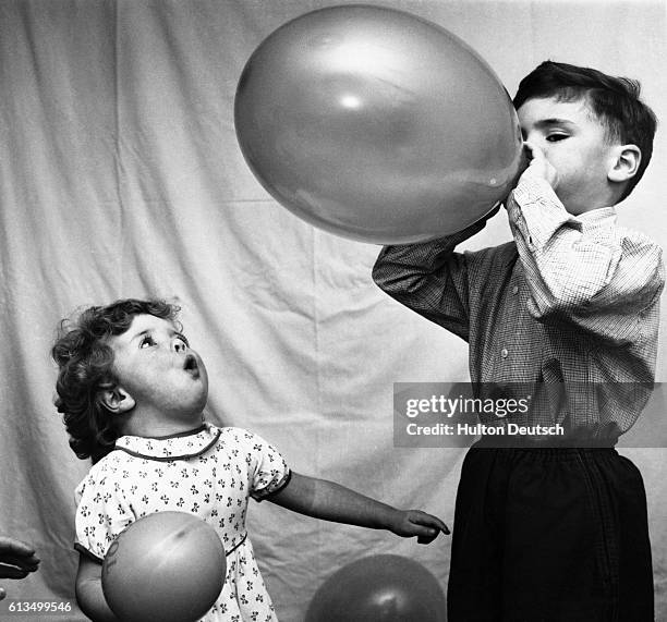 Six-year old Stephen Burton and his sister Susan play with balloons.