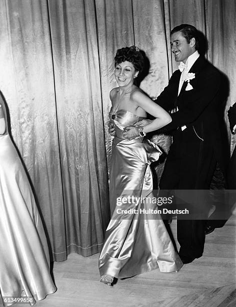 Ann Boyar Warner dances with American actor Errol Flynn at Carrolls, a top Hollywood restaurant.