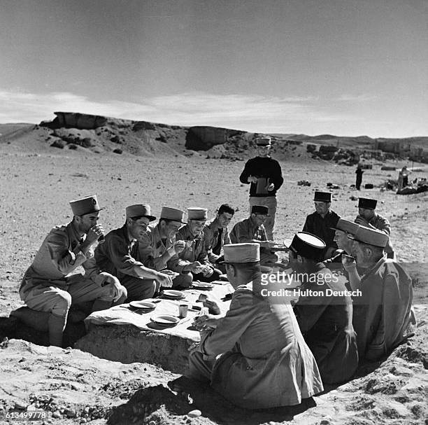 Under officers of the French Foreign Legion use items on hand to make a table for their meal while in the deserts of North Africa, 1939.