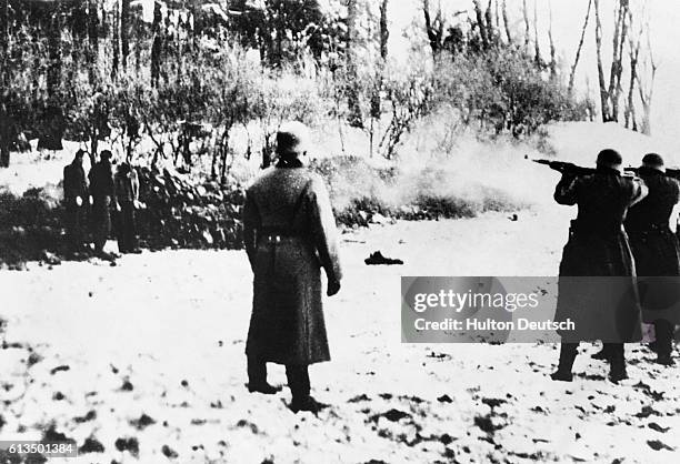 Polish men watch helplessly as a Nazi firing squad picks their fellow prisoners off methodically, from right to left. The Nazis treated Poles as...